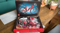 Inside the LEGO bike box, with all its parts in their packets, ready to be assembled